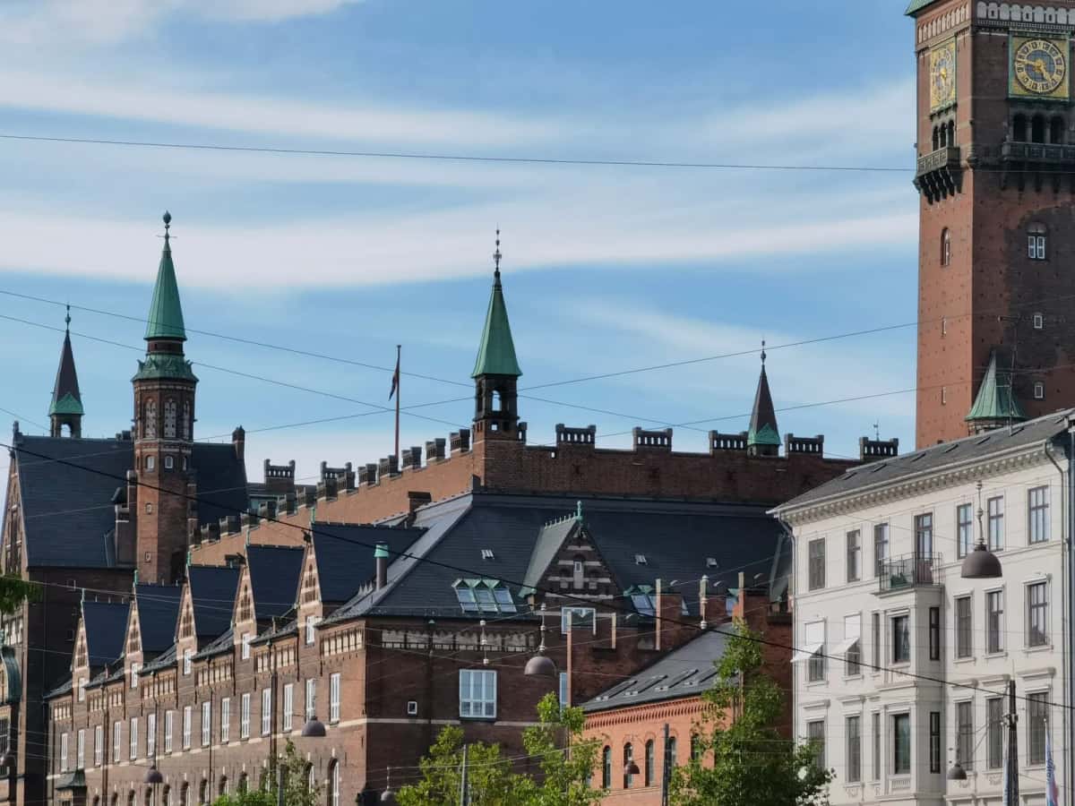 L'hôtel de ville de Copenhague en brique rouge et sa haute tour de l'horloge, dépassant les toits des immeubles voisins