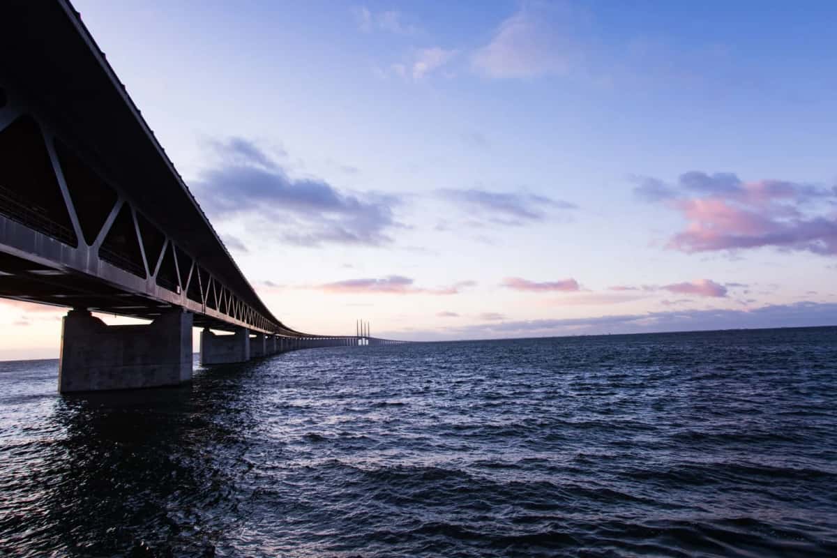 Le pont de l'Øresund reliant le Danemark à la Suède au crépuscule, vu depuis le rivage