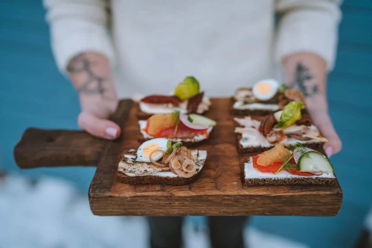 Planche de smørrebrød danois, tartines de pain de seigle garnies de hareng, œuf et crevettes